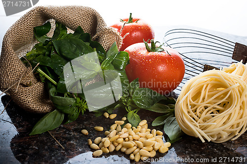 Image of Italian cooking ingredients on a black granite tabletop.