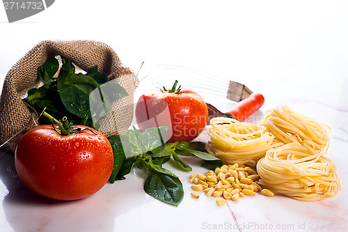 Image of Italian cooking ingredients on a white marble tabletop.