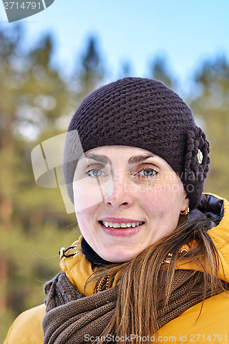 Image of woman in yellow jacket in nature