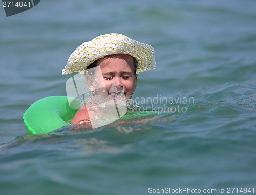 Image of little girl in sea on inflatable disc