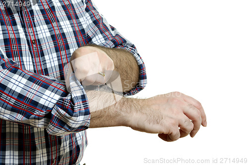 Image of Man rolls up sleeves