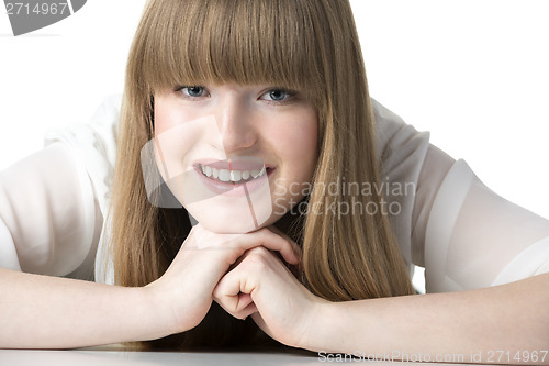 Image of Laughing blond girl on table