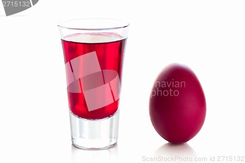 Image of Red easter egg with a glass of drink