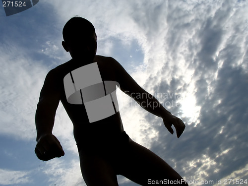 Image of A black silhouette of a young guy in the sky