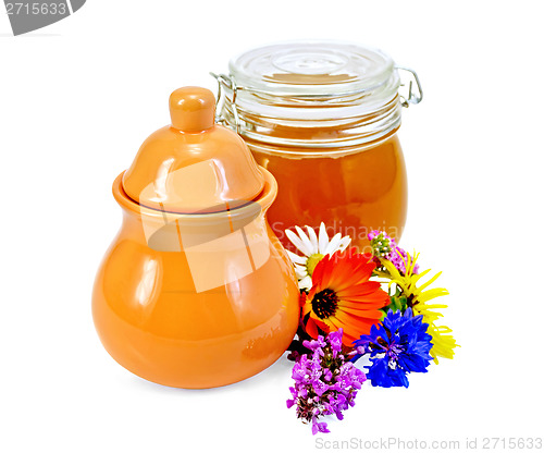 Image of Honey in a jug and jar with flowers