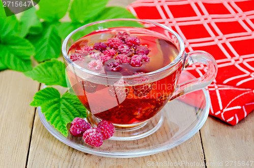 Image of Tea with raspberry and a napkin on board