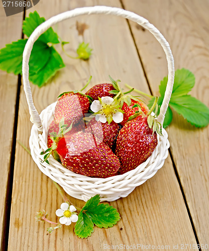 Image of Strawberries in basket with flowers on board