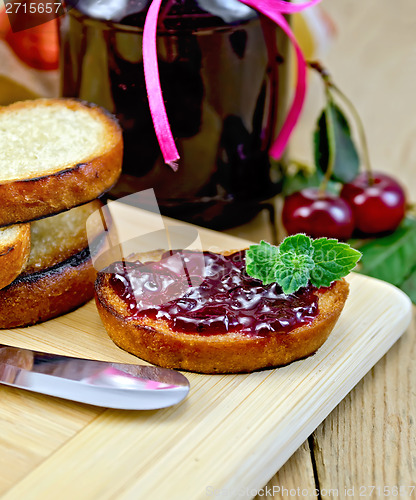 Image of Bread with cherry jam on a board