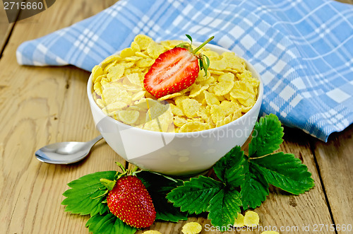 Image of Cornflakes in white bowl with strawberries on board