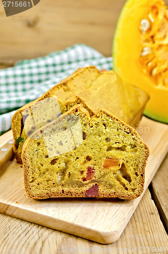 Image of Fruitcake pumpkin with candied fruit and knife on board