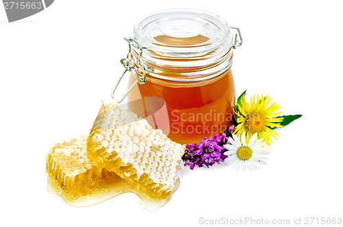 Image of Honeycomb with a jar and flowers