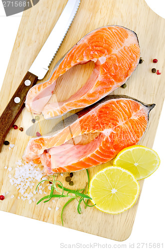 Image of Trout with rosemary and knife on plank