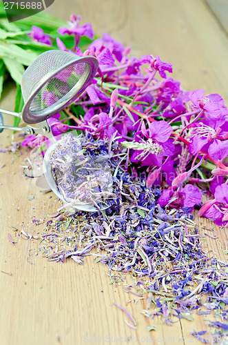 Image of Herbal tea with strainer of fireweed on board