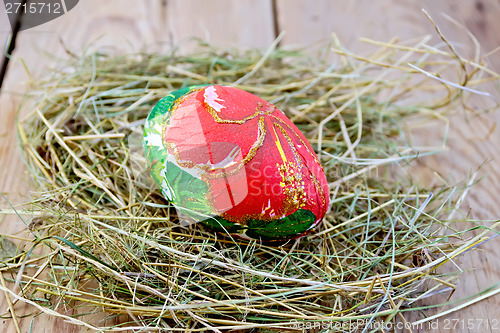 Image of Easter egg with red flower on board