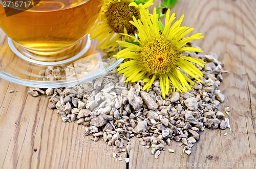 Image of Herbal tea from the root of elecampane with cup and flower