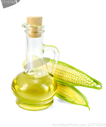 Image of Corn oil in a carafe with two cobs