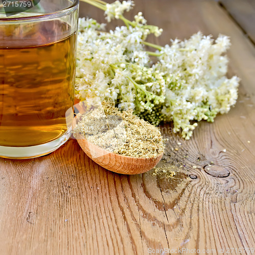 Image of Herbal tea of meadowsweet dried in spoon and mug