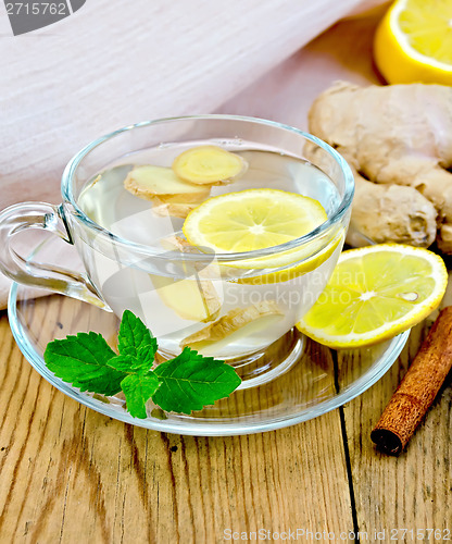 Image of Tea ginger with lemon in a cup on board