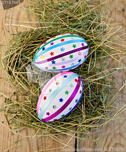 Image of Easter eggs with ribbons and sequins on board