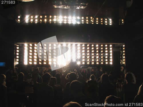 Image of dj behind the board and dancing young people