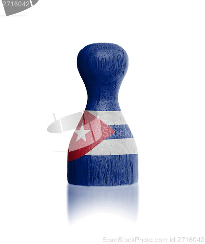 Image of Wooden pawn with a painting of a flag