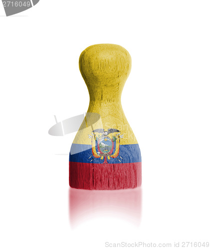 Image of Wooden pawn with a painting of a flag