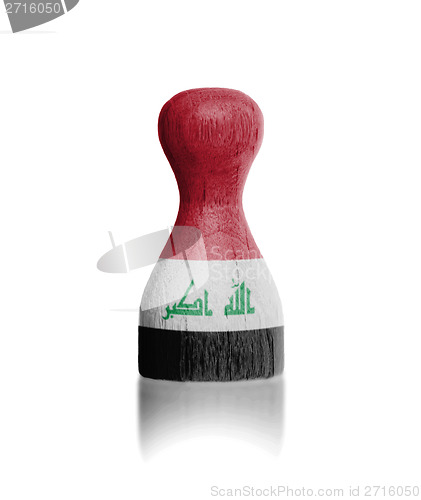 Image of Wooden pawn with a flag painting