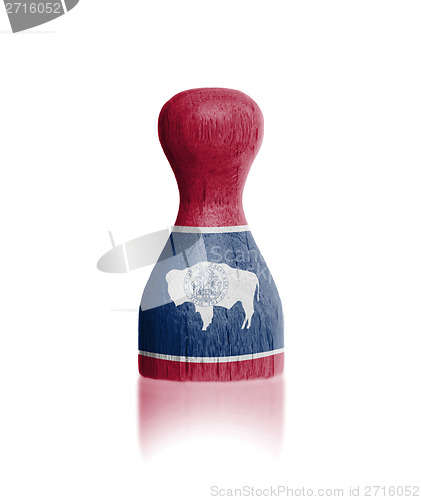 Image of Wooden pawn with a painting of a flag