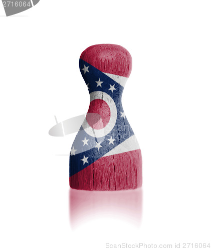 Image of Wooden pawn with a painting of a flag