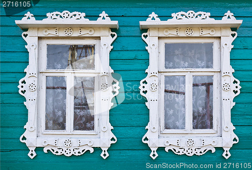 Image of Wooden platbands on two window of an village house