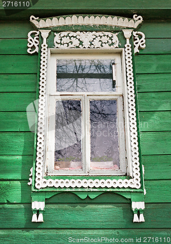 Image of Window with white trim on the green wall