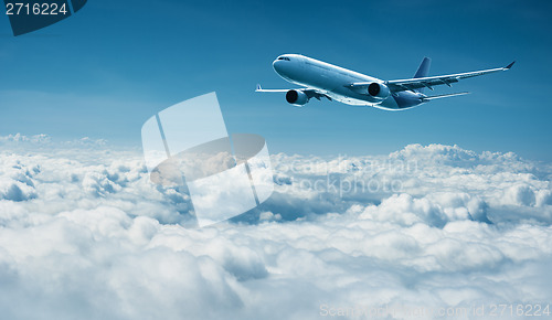 Image of Airplane flies above clouds - air travel