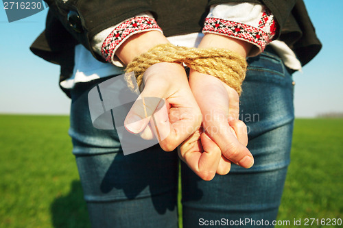 Image of Hands tied up with rope