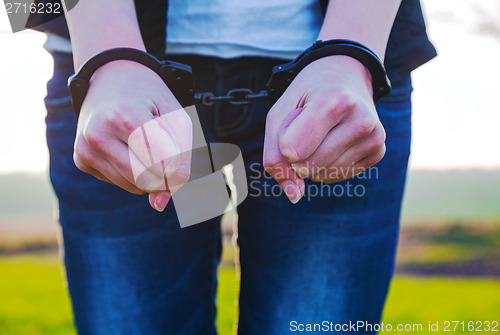 Image of Handcuffed woman hands