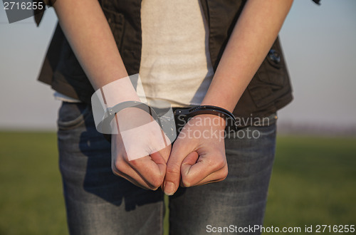 Image of Handcuffed woman's hands