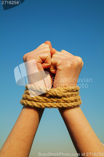 Image of Hands tied up with rope