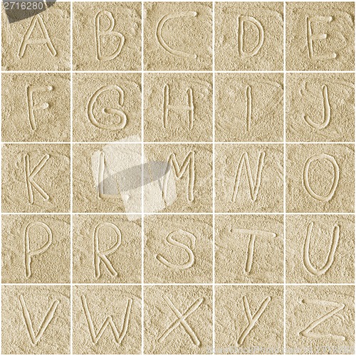 Image of handwritten alphabet letters on sand