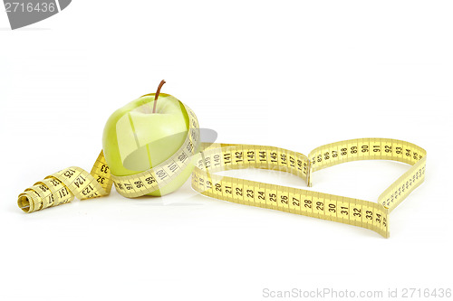 Image of green apple with a measuring tape and heart symbol isolated