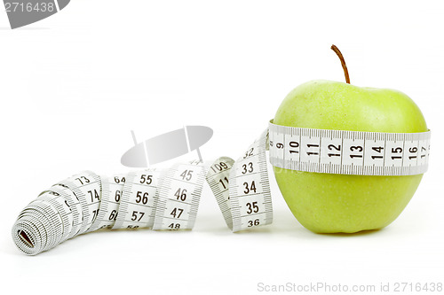 Image of green apple with a measuring tape and heart symbol isolated