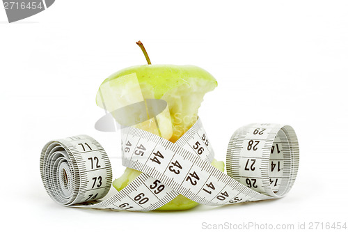 Image of Green bitten apple isolated on white with measuring tape