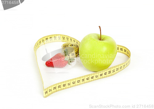 Image of green apple with a measuring tape and heart symbol isolated