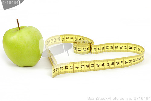 Image of green apple with a measuring tape and heart symbol isolated
