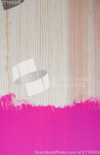 Image of Splash of painted colour on pine plank