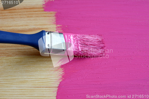 Image of Pine board being painted 