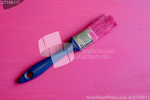 Image of Dirty paintbrush on painted pine