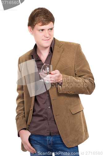 Image of Handsome man posing with a glass of whiskey