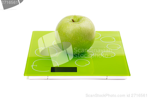 Image of Green apple on scales