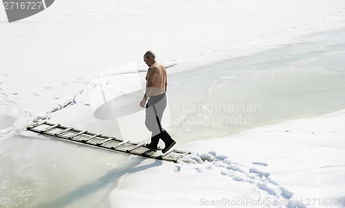 Image of Man walking on ice