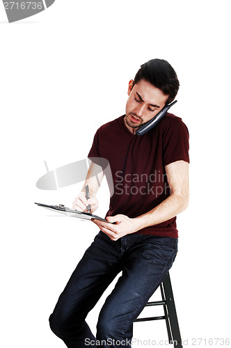 Image of Man on phone and writing.