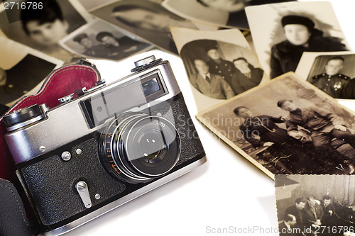 Image of The old film camera and ancient photos on a white background.